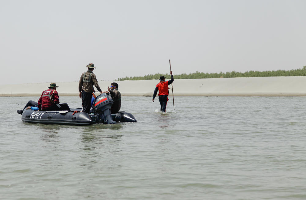 A Pakistan Navy seaman walks through shallow water near a sand bank to find a path for the crew. Parts of the lower stretches of the Indus are so shallow it cannot even float a dinghy.