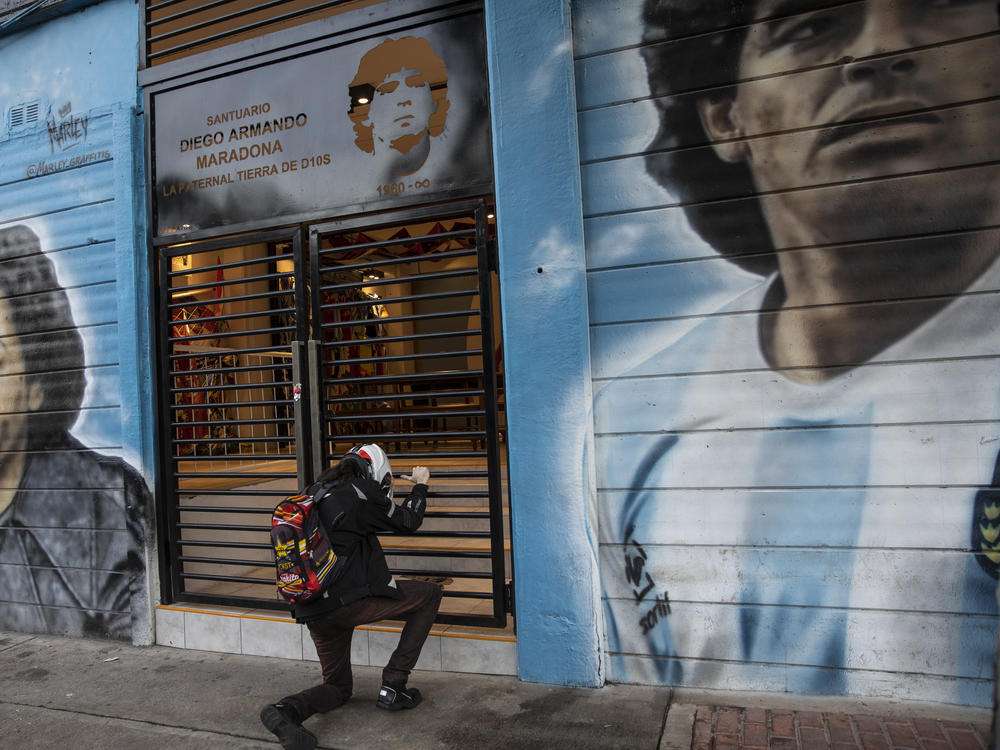 A man prays in front of a sanctuary for the late soccer star Diego Maradona at Argentinos Juniors stadium in Buenos Aires, Argentina, last November.