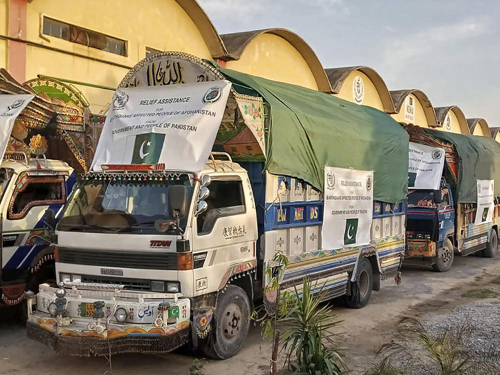 In this photo released by Pakistan's National Disaster Management Authority, a convoy of trucks carrying relief goods prepare to leave for Afghanistan at a warehouse in Islamabad, Pakistan, Thursday, June 23, 2022.
