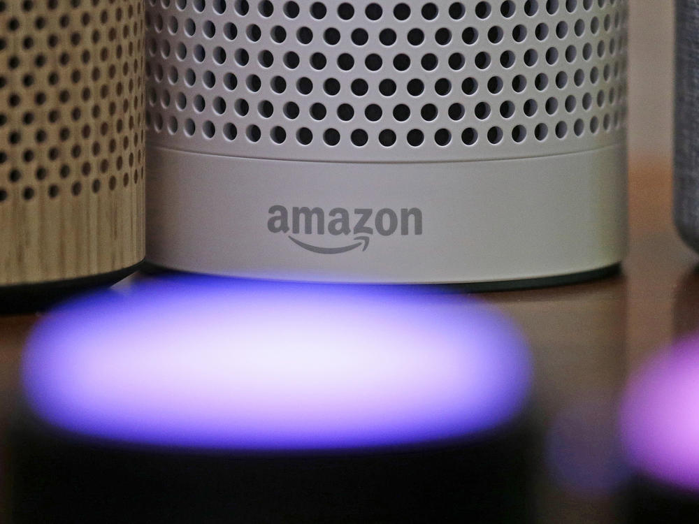 Amazon Echo and Echo Plus devices behind illuminated Echo Button devices during an event by the company in Seattle in September 2017.