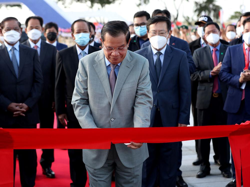 Cambodia's Prime Minister Hun Sen cuts a ceremonial ribbon for a stadium in Phnom Penh paid for by China's Belt and Road Initiative in this December 2021 photo.