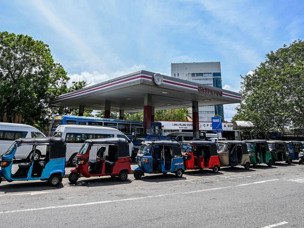 Autorickshaws are lined up to get fuel in Colombo, Sri Lanka, on Monday. COVID and energy price spikes have exacerbated deep-seated economic problems in the country.