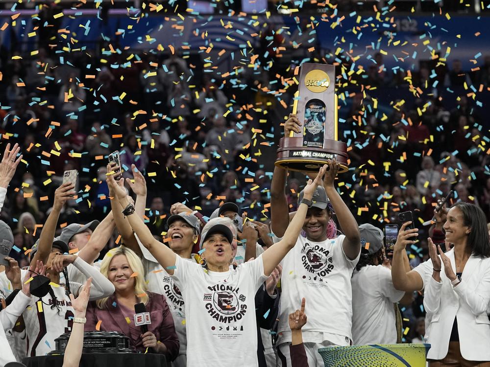 South Carolina head coach Dawn Staley celebrates with her team after a college basketball game in the final round of the Women's Final Four NCAA tournament against UConn, April 3, 2022, in Minneapolis.