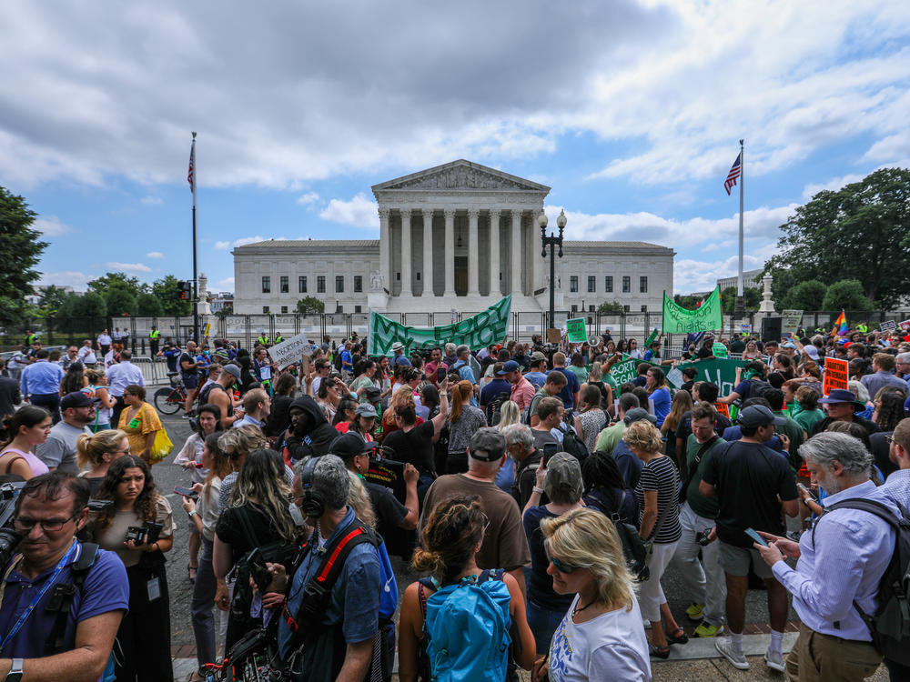 Abortion rights demonstrators hold signs outside the Supreme Court in Washington, D.C., on Friday.