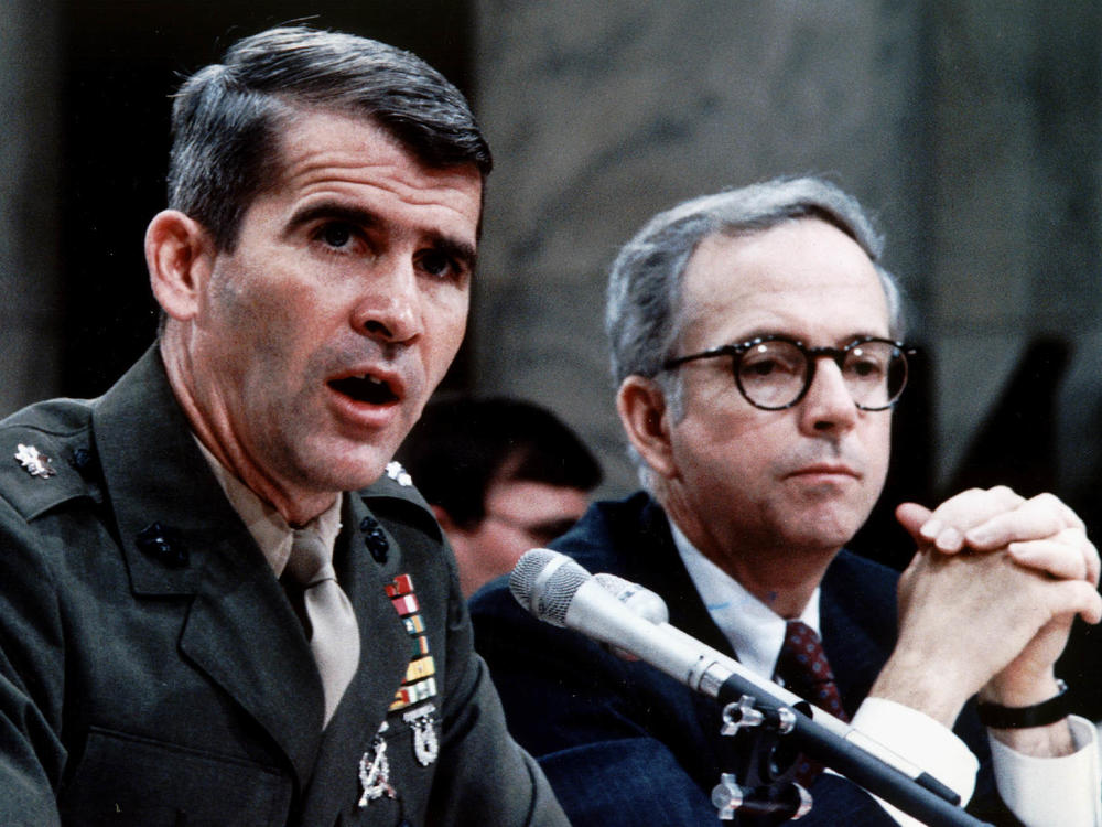 Marine Corps Lt. Col. Oliver North, accompanied by his lawyer Brendan Sullivan, was a central figure in the Iran-Contra hearings.