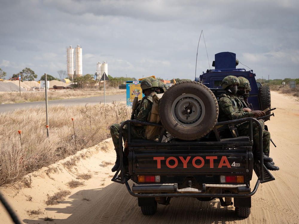 Soldiers patrol near the TotalEnergies complex in Cabo Delgado, Mozambique. Last year the insurgency caused TotalEnergies to put onshore operations on hold. But Italy's ENI and ExxonMobil are moving ahead with a new floating LNG ship offshore. It plans to deliver its first LNG later this year.