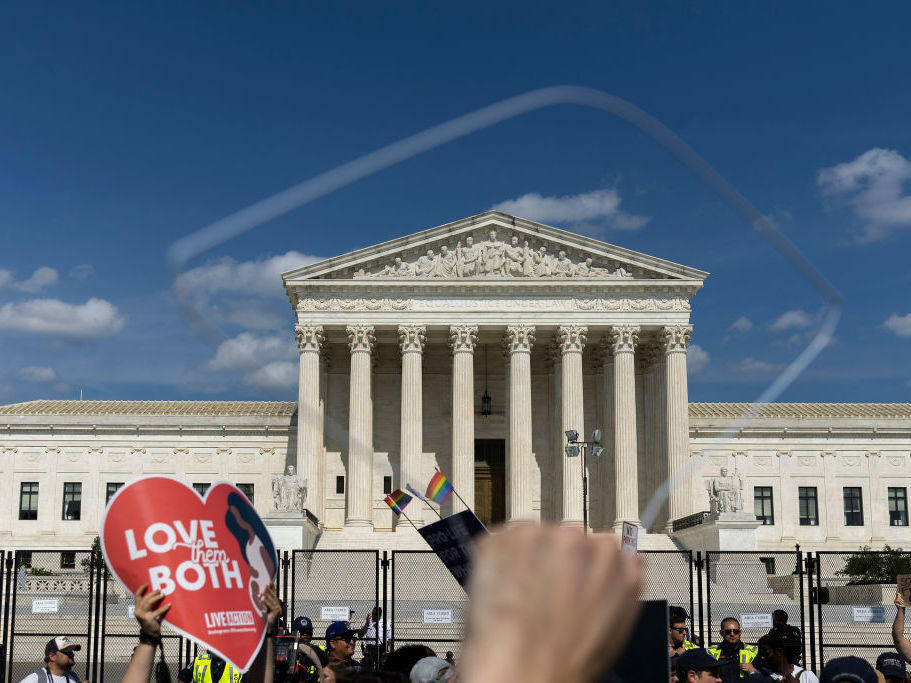 Abortion-rights protesters and anti-abortion protesters gather Sunday outside the U.S. Supreme Court in Washington.