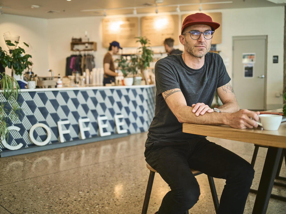 Scott Lucey, owner of Likewise Coffee whose staff unionized in 2020, sits for a portrait on June 9, 2022 in Milwaukee.