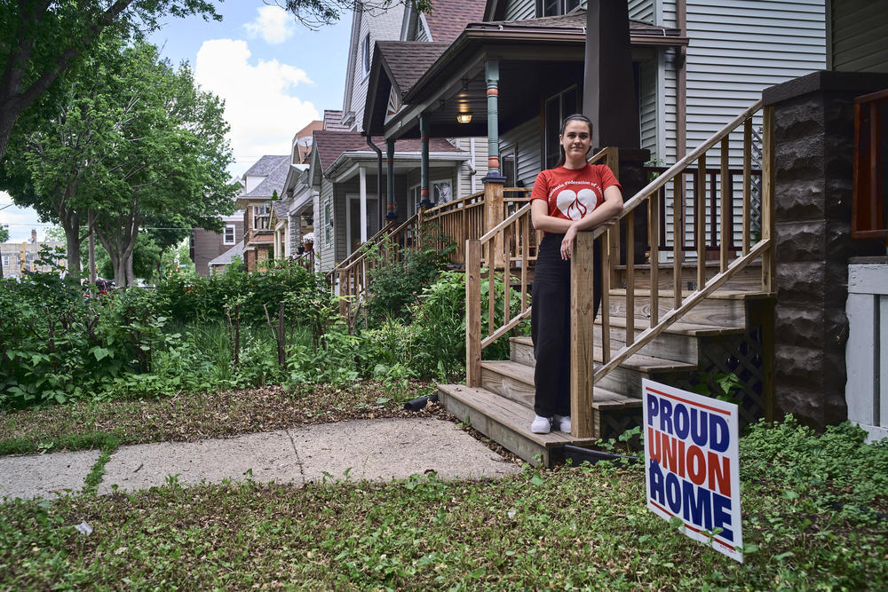Kellie Lutz, who launched a union campaign at Stone Creek Coffee in 2019, stands outside her home in Milwaukee. Lutz is now a certified nursing assistant and a union shop steward with the Wisconsin Federation of Nurses & Health Professionals. She recently helped negotiate a union contract.