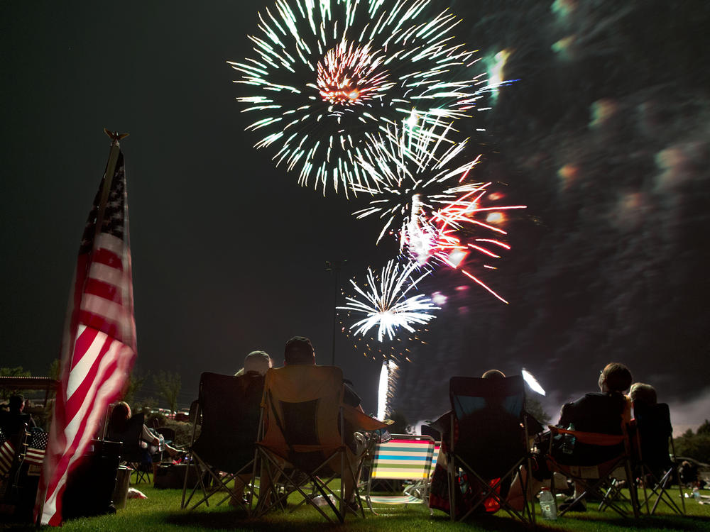 Spectators watch as fireworks explode overhead during the Fourth of July celebration at Pioneer Park, on July 4, 2013, in Prescott, Ariz.
