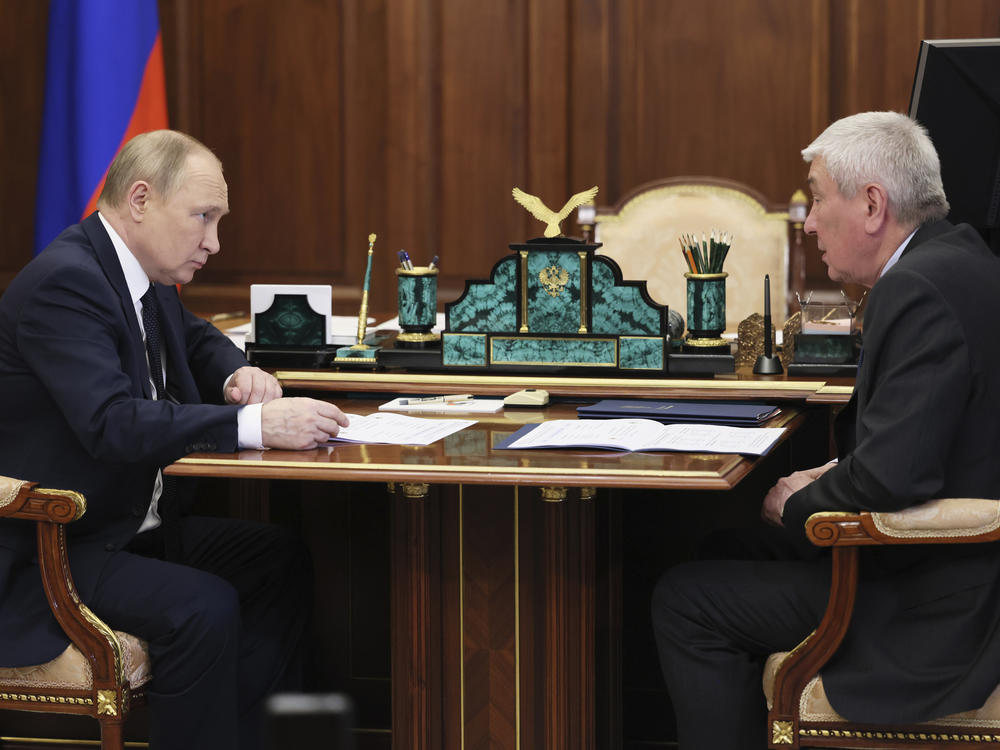 Russian President Vladimir Putin meets with the head of Russia's Federal Financial Monitoring Service, Yury Chikhanchin, at the Kremlin in Moscow on Monday.