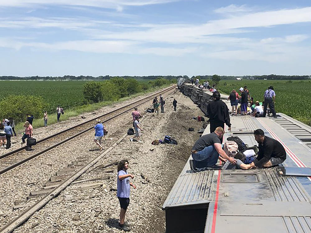 An Amtrak passenger train lies on its side after derailing near Mendon, Mo., on Monday.
