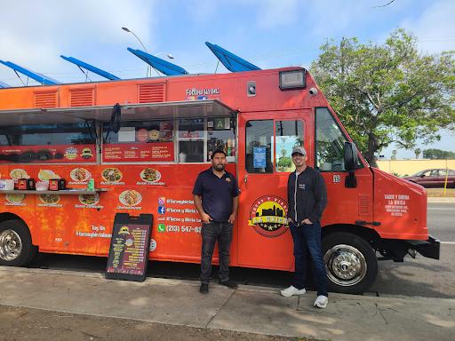 Yasmany Mendoza and A Martinez in front of Tacos y Birria La Unica on Venice Boulevard.