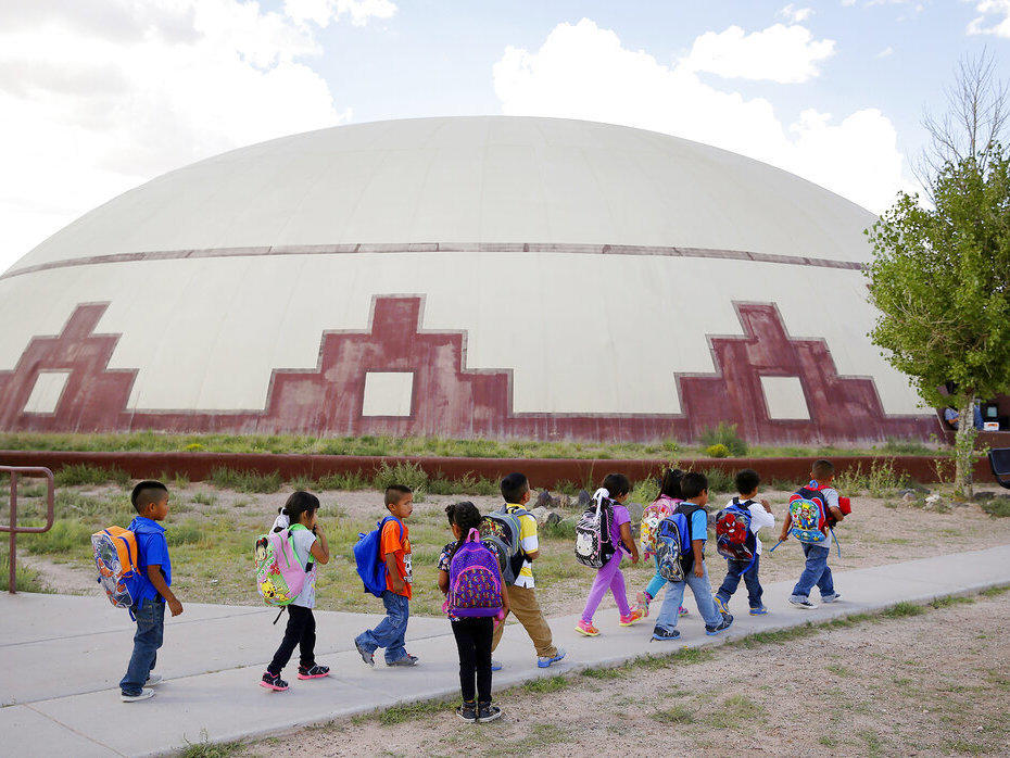 Students walk between buildings in September 2014 at the Little Singer Community School in Birdsprings, Ariz., on the Navajo Nation.