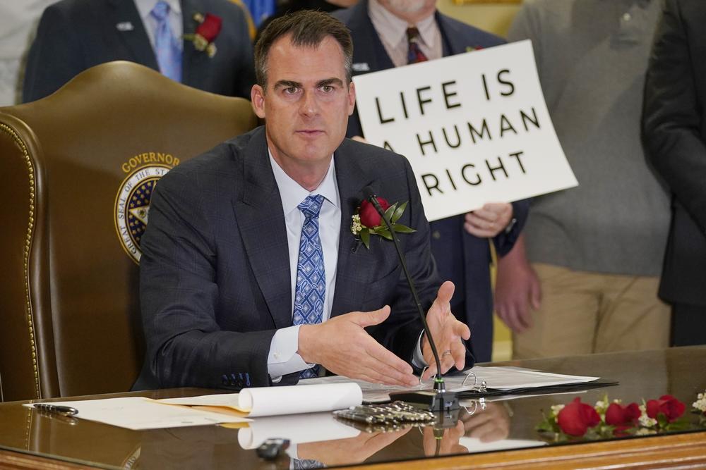 In Oklahoma City, Republican Gov. Kevin Stitt speaks after signing into law April 12, 2022, that makes it a felony to perform an abortion, punishable by up to 10 years in prison. Stitt is up for reelection in November.