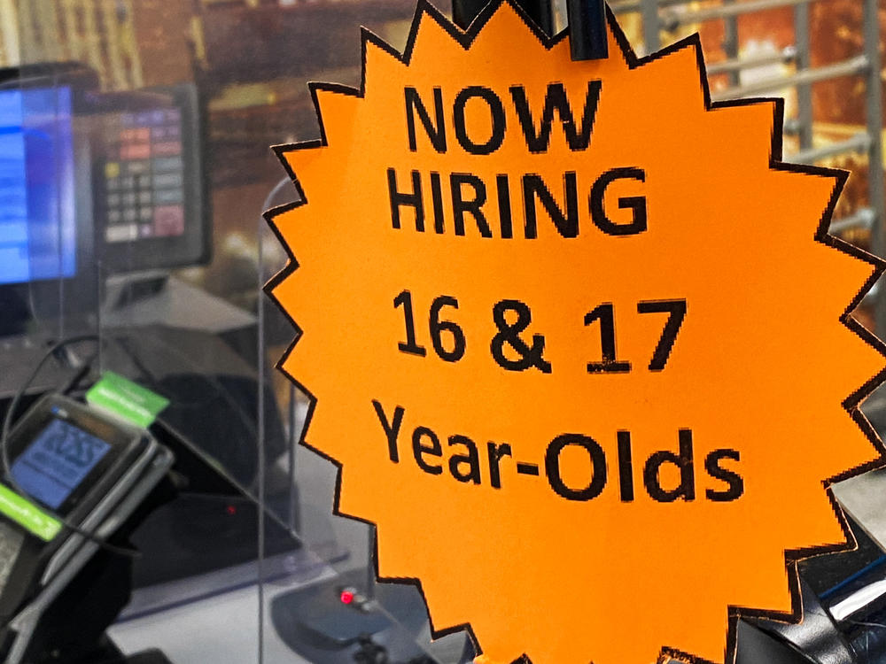 Signage advertising now hiring for 16- and 17-year-old employees is displayed on a cash register inside a discount department retail store in Las Vegas.