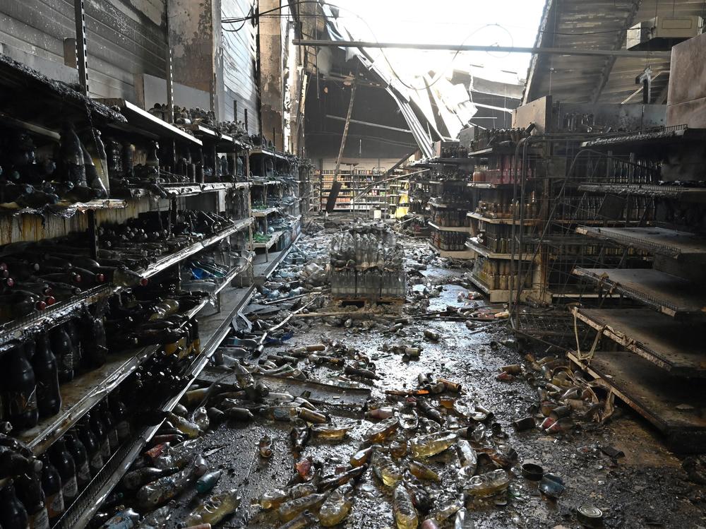 A photograph taken Tuesday shows charred goods in a grocery store of the destroyed Amstor mall in Kremenchuk, central Ukraine, one day after it was hit by a Russian missile strike.