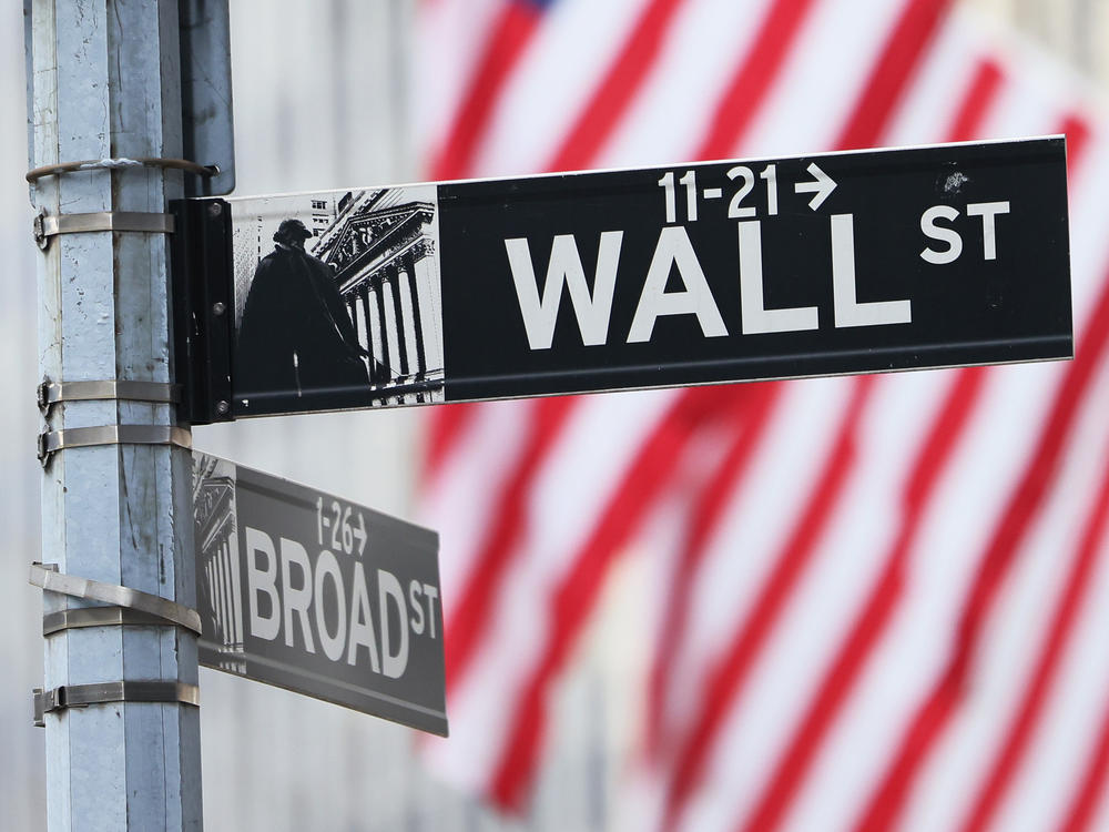 A Wall Street sign is seen outside of the New York Stock Exchange during morning trading on June 08, in New York City.