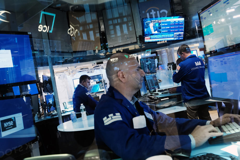 Traders work on the floor of the New York Stock Exchange on June 16. Stocks fell sharply in morning trading as investors react to the Federal Reserve's largest rate hike since 1994.
