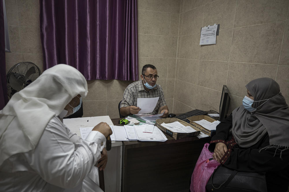 Dr. Saher Abu Ghali (center), the Gaza cardiac surgeon, meets with a patient's family.