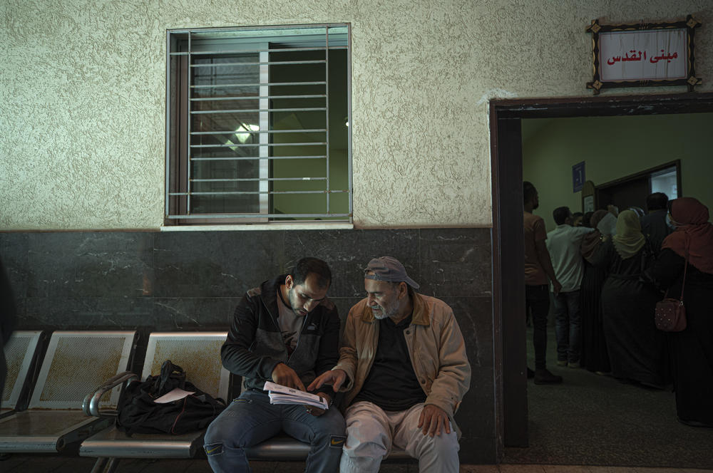 Yousef Al-Kurd waits with his son Ibrahim to be seen by a doctor in Gaza. After a sudden heart attack on April 1, 2020, Al-Kurd needed open heart surgery.