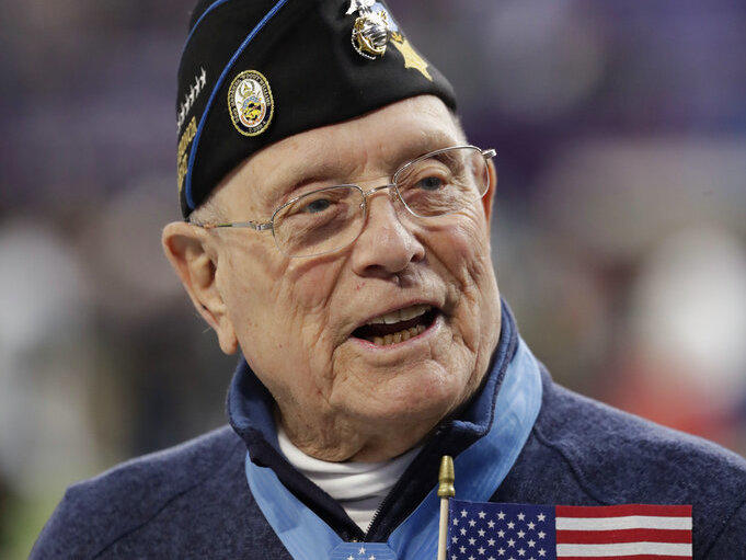 Woody Williams assists with the coin toss before Super Bowl 52 in February 2018 in Minneapolis. Williams, the last remaining Medal of Honor recipient from World War II, died Wednesday at 98, at the Veterans Affairs medical center bearing his name in Huntington, W.Va.