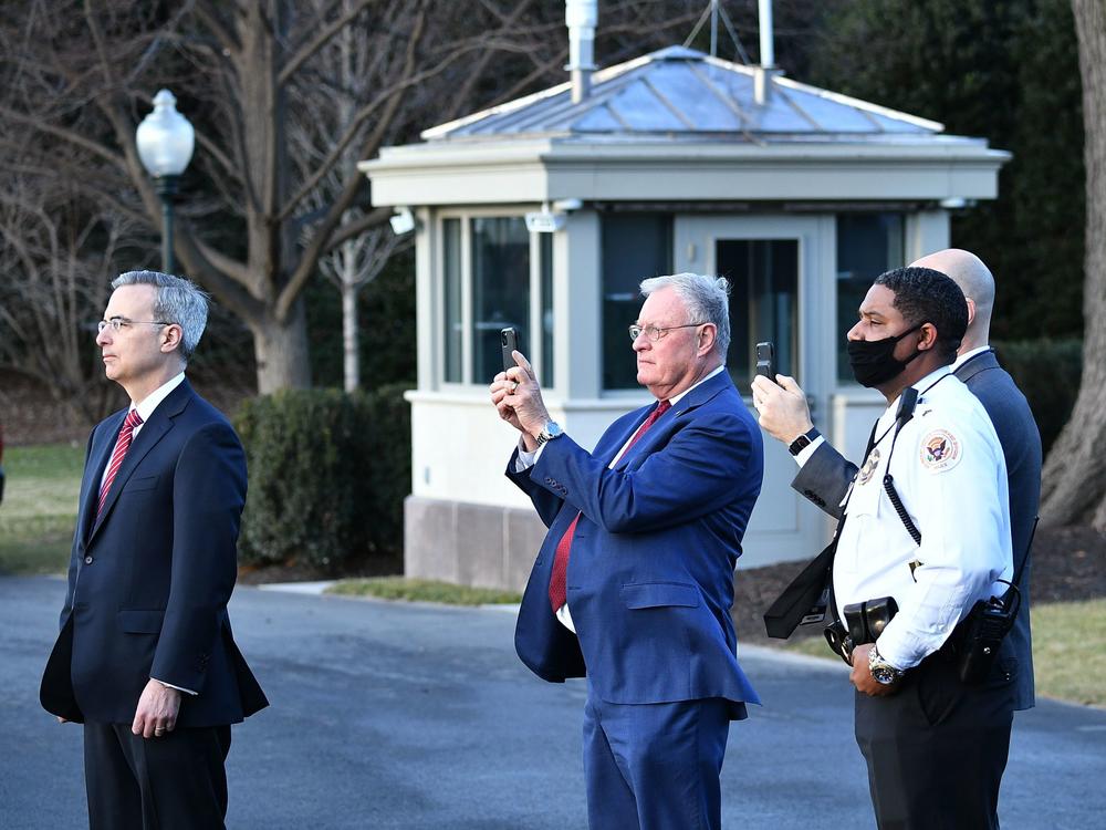 White House Counsel Pat Cipollone, left, is seen with Keith Kellog, center, national security adviser to Vice President Mike Pence, watching Marine One carrying President Donald Trump leave the White House ahead of President-elect Joe Biden's inauguration on Jan. 20, 2021.