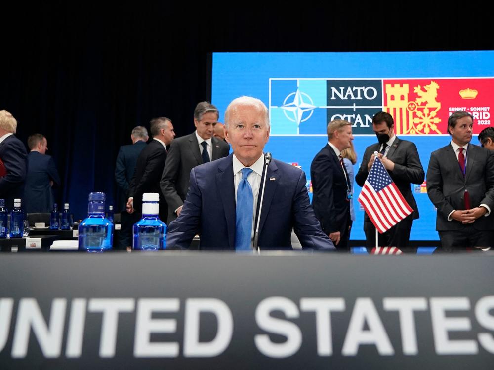 President Biden waits for the start of a roundtable meeting at the NATO summit in Madrid. He announced the U.S. would increase its military presence in Europe.