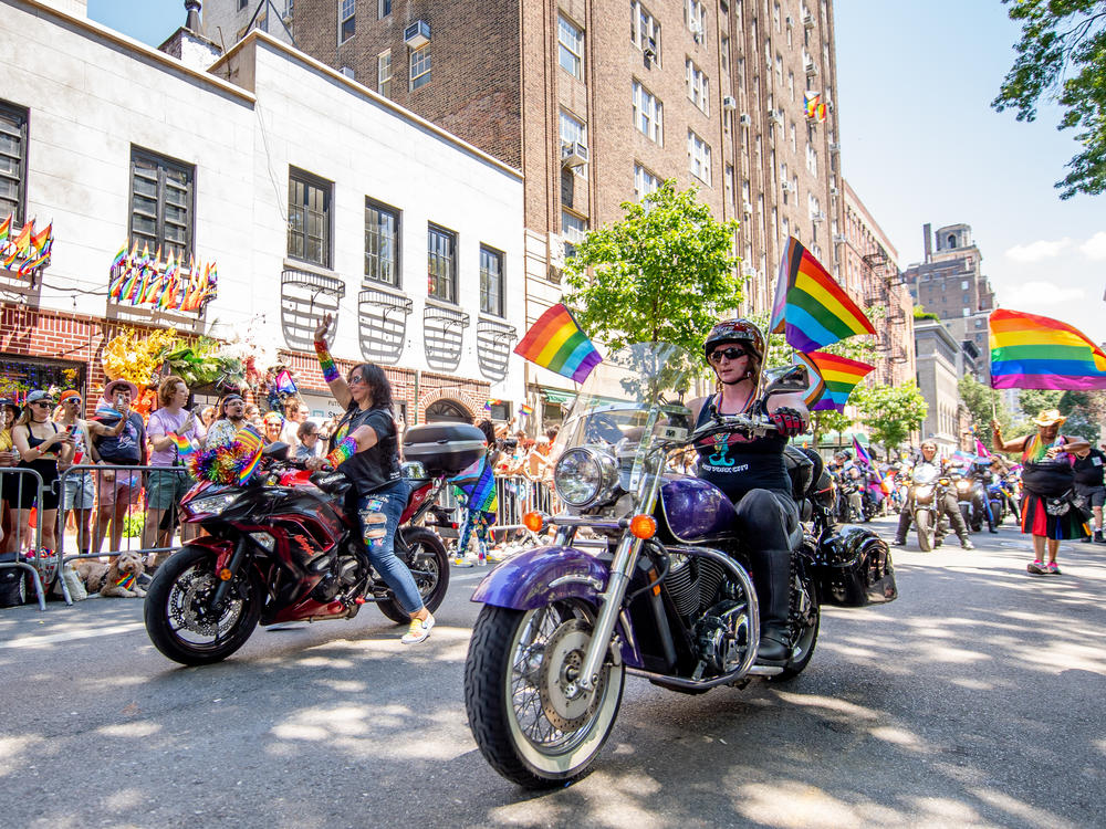 Participants pass in front of the Stonewall Inn during the New York City Pride parade.