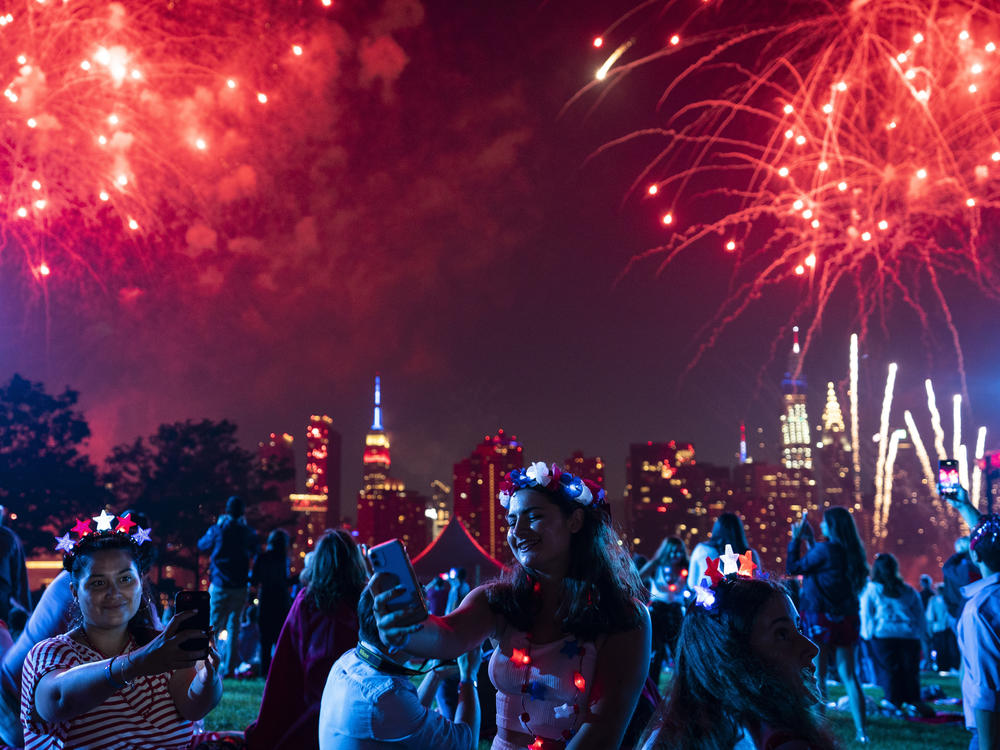 Spectators watch as fireworks are launched over the East River and the Empire State Building in New York City on July 4, 2021. Regulators are warning people ahead of July Fourth to be careful handling any recreational fireworks.