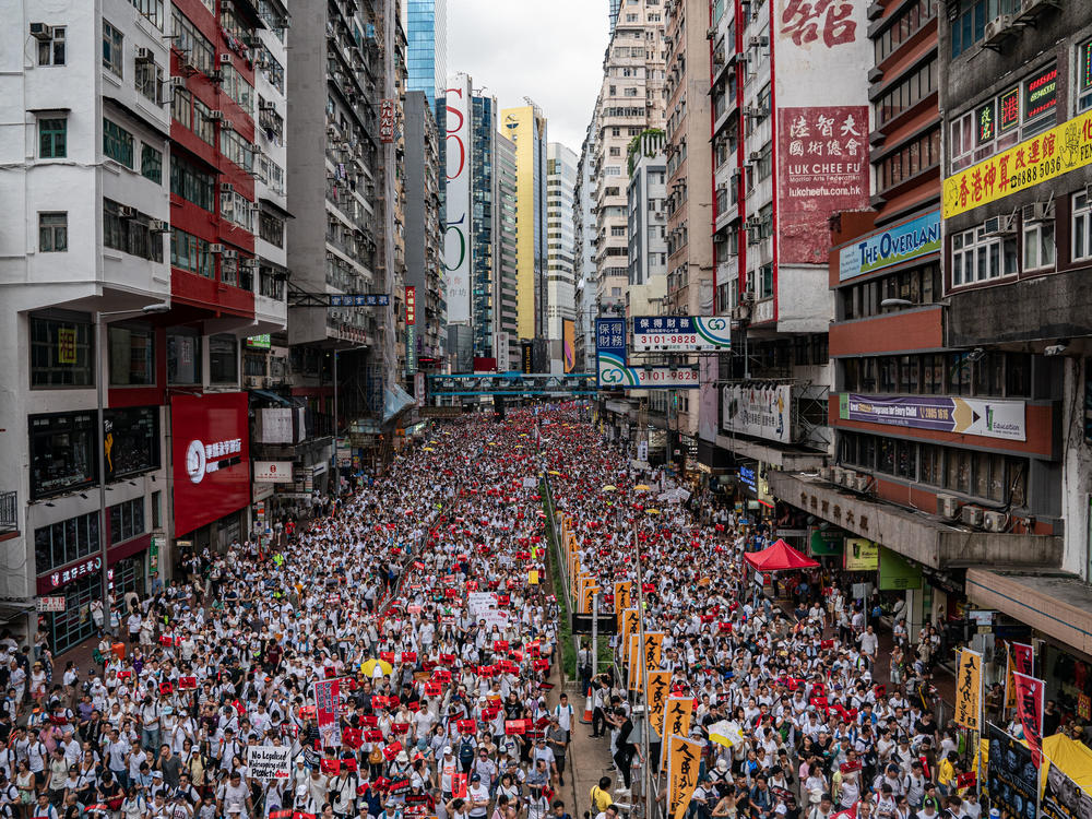 Protesters march on a street during a rally against the extradition law proposal on June 9, 2019 in Hong Kong.