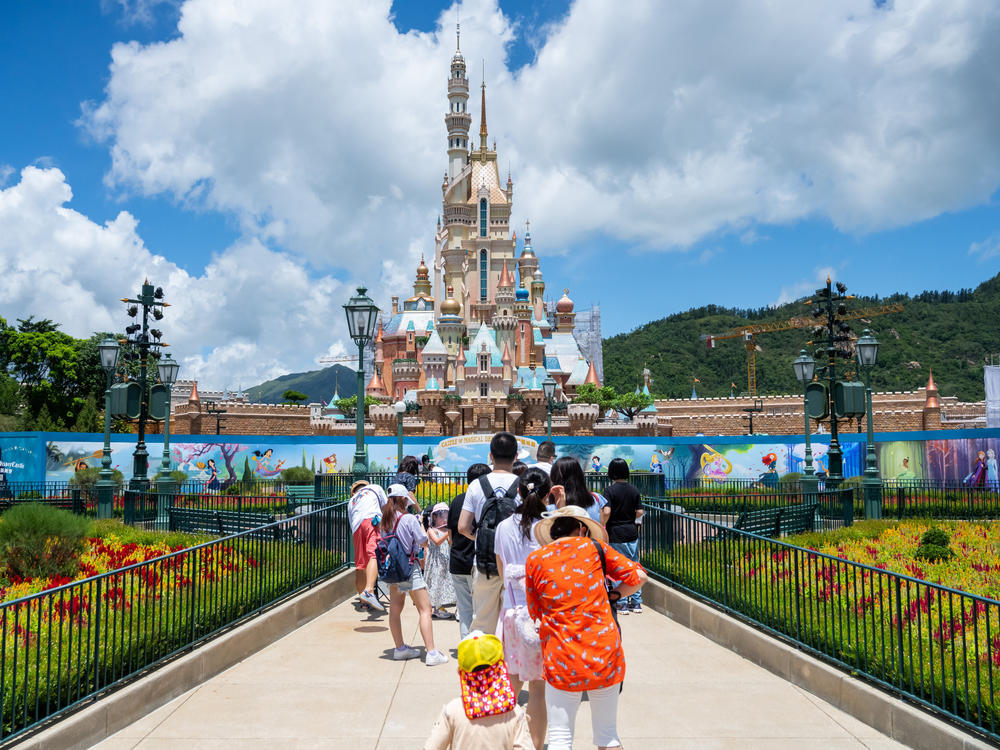 Visitors take photos at the  Disneyland Resort in Hong Kong on June 18, 2020.
