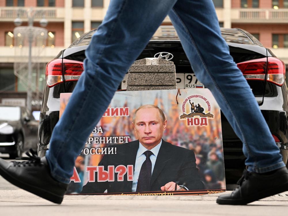 A placard featuring an image of Russian President Vladimir Putin and reading 