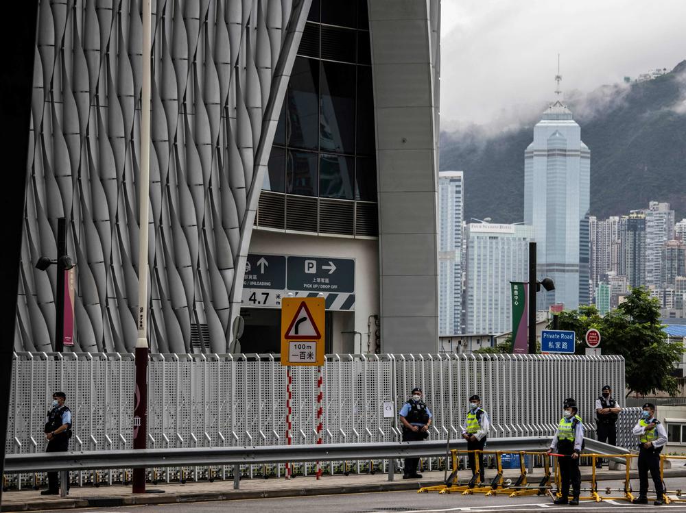 Police guard a closed road outside the Xiqu Centre in Hong Kong on June 30, 2022, as Chinese President Xi Jinping arrives in Hong Kong to attend celebrations marking the 25th anniversary of the city's handover from Britain to China.