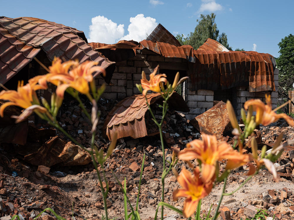 A destroyed building next to flowers on Thursday in Borodianka, Ukraine. The region around Ukraine's capital continues to recover from Russia's aborted assault on Kyiv, which turned many communities into battlefields.