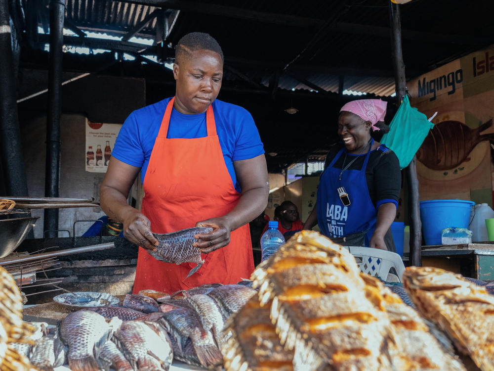 Florence Aluoch Odero prepares fish for frying at Migingo Island Hotel, a food stall in Nairobi's Kenyatta Market. Her expenses are soaring due to inflation.