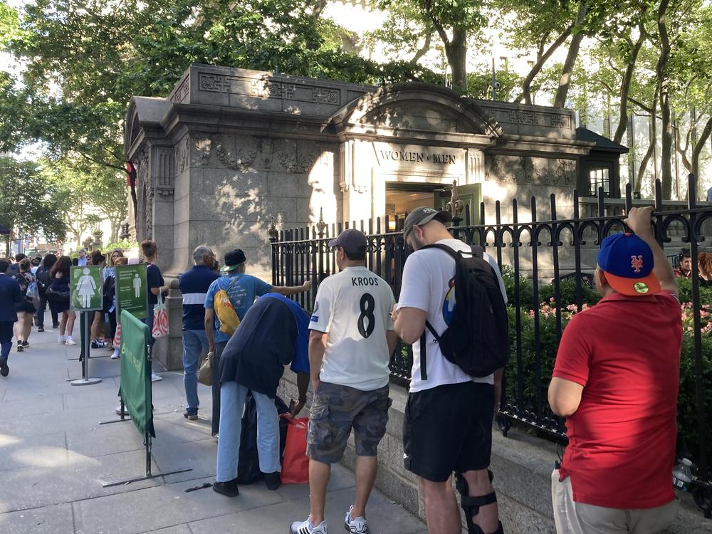 People wait in line to use a public restroom at Bryant Park, in midtown Manhattan, on June 28.