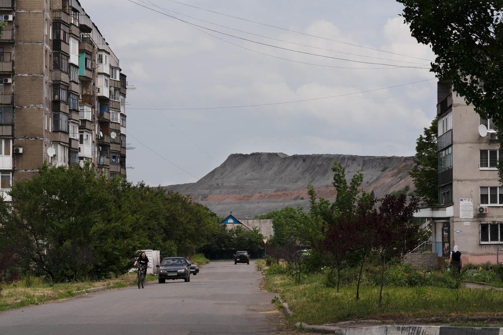 A slag heap rises behind residential buildings in Dobropillia, a town in the Donbas. Ninety percent of the country's coal is believed to be in the Donets coal basin in the Donbas region.