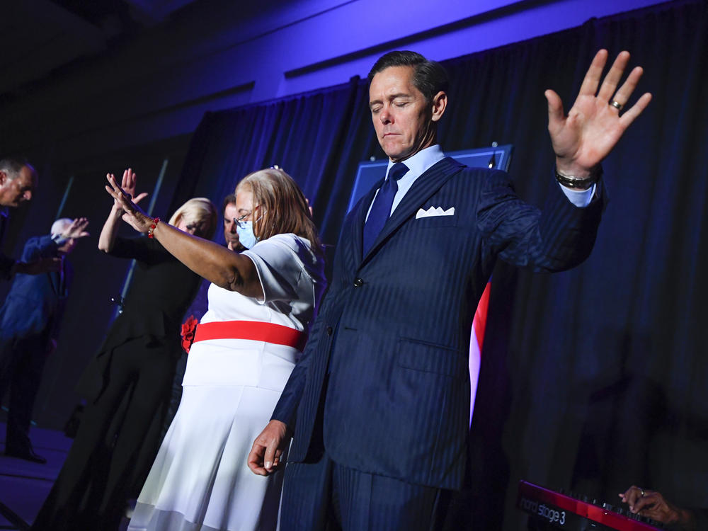 Ralph Reed prays on stage during a Donald Trump campaign event courting devout conservatives by combining praise, prayer and patriotism, Thursday, July 23, 2020, in Alpharetta, Ga.
