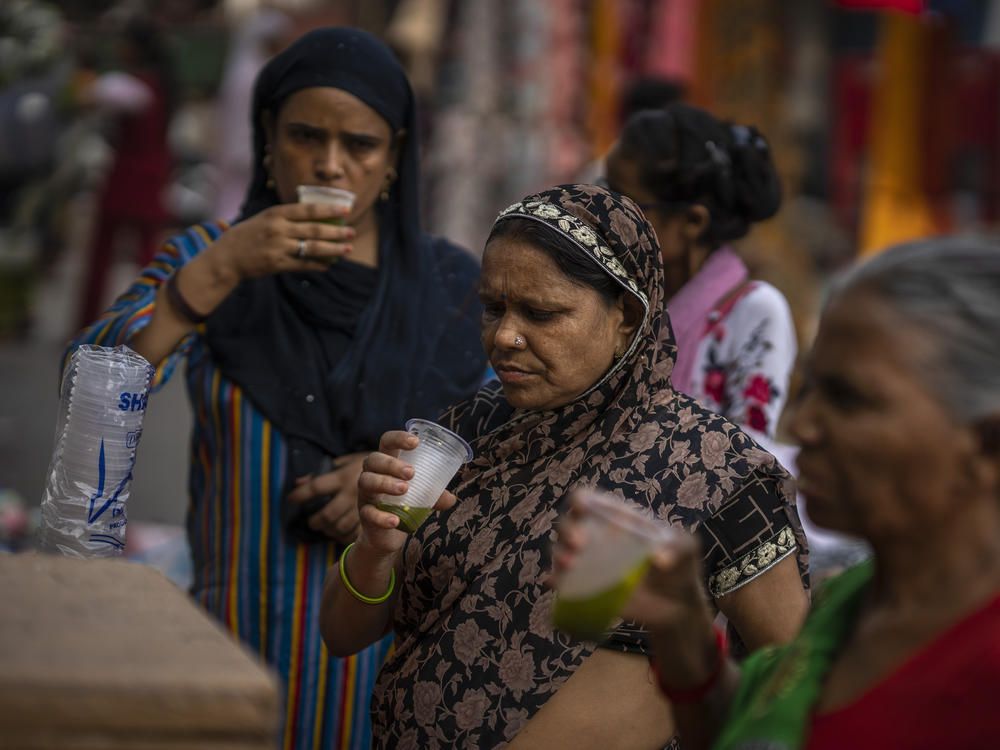 Shoppers drink juice in plastic cups at a market in New Delhi, on Wednesday. India banned some single-use or disposable plastic products Friday as part of a longer plan to phase out the ubiquitous material in the nation of nearly 1.4 billion.