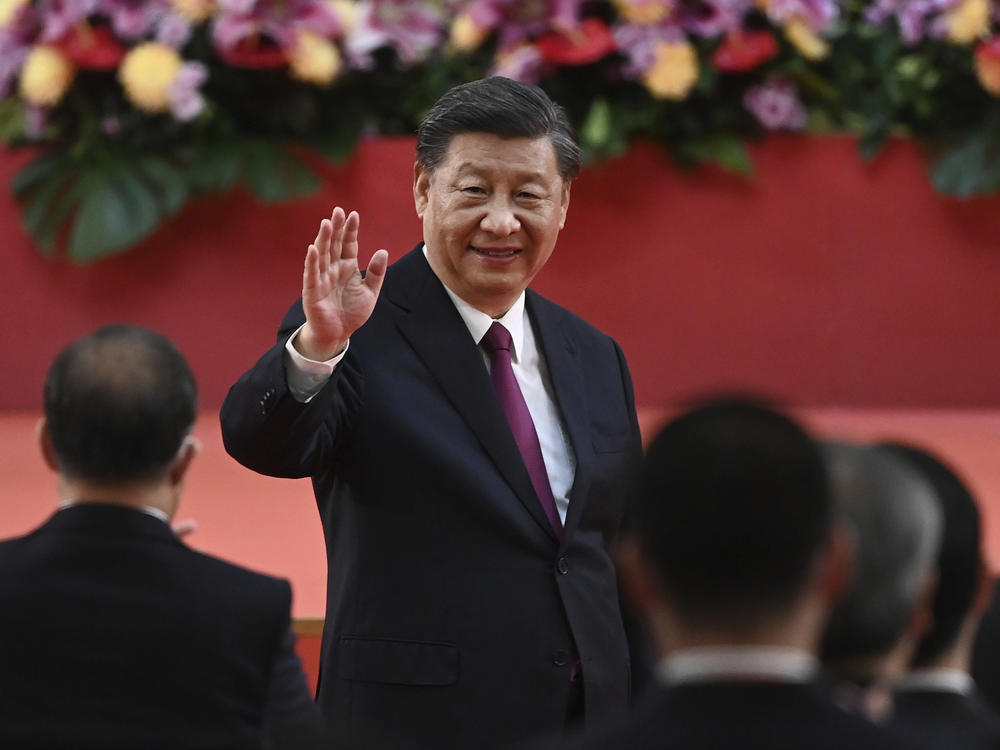 China's President Xi Jinping waves following his speech after a ceremony to inaugurate the city's new government in Hong Kong Friday, July 1, 2022, on the 25th anniversary of the city's handover from Britain to China.