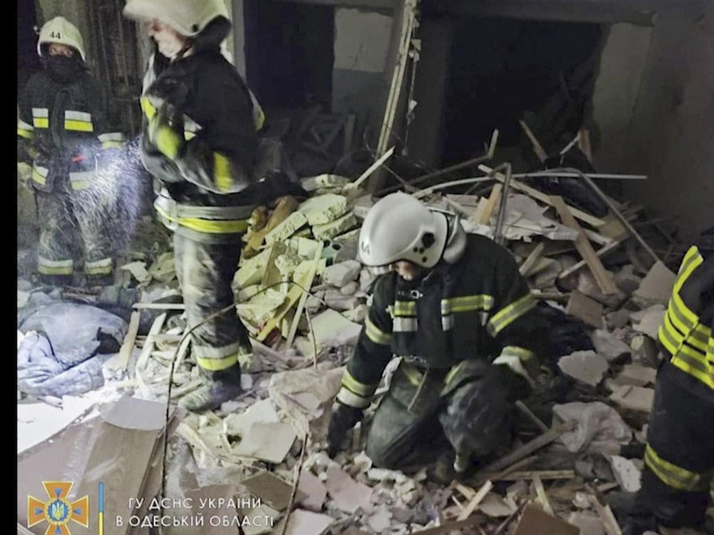 In this photo provided by the Ukrainian Emergency Service, first responders work a damaged residential building in Odesa, Ukraine, early Friday, July 1, 2022, following Russian missile attacks.