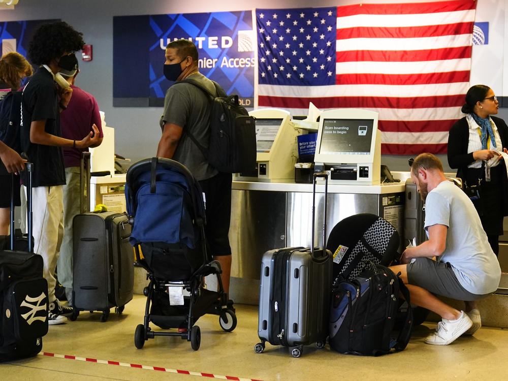 Travelers check in at Philadelphia International Airport on Friday.