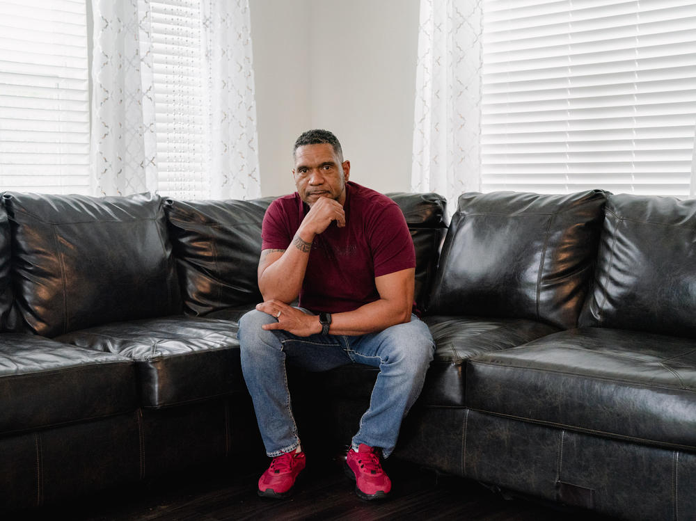 Tyrone Ferrens, a plant electrician at Under Armour, sits for a portrait in his house in Aberdeen, Md.