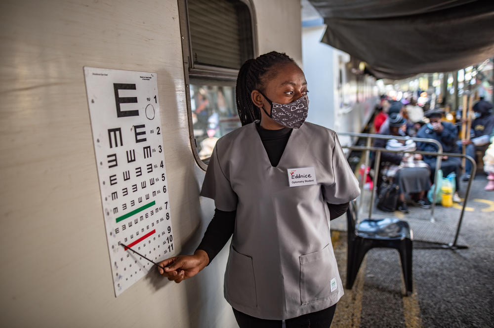 With a medical staff of 22, the Phelophepa train of South Africa provides health care to residents in need. Above: An optometry student carries out an eye test during a visit to the town of Kroonstad in South Africa's Free State province.