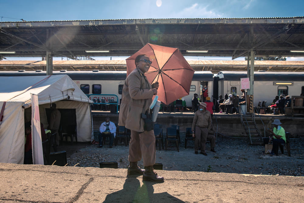 Corrections officer Sesi Motsoaleli watches over a group of prisoners who have been brought to the Phelophepa health-care train during a stop in Kroonstad, South Africa, for various medical procedures and checks. The prison sends its inmates here whenever the train is in town.