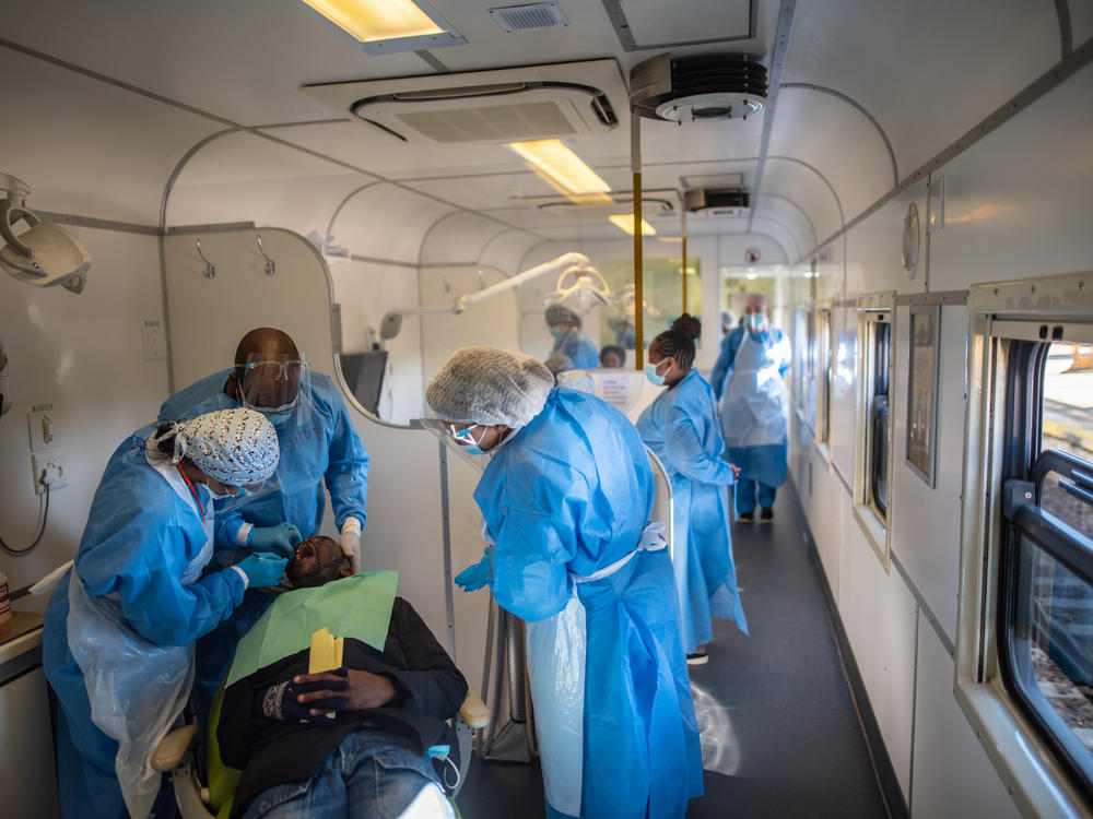 Health care workers see to a patient in the dental carriage of the Phelophepa during a stop at Kroonstad in South Africa's Free State province.