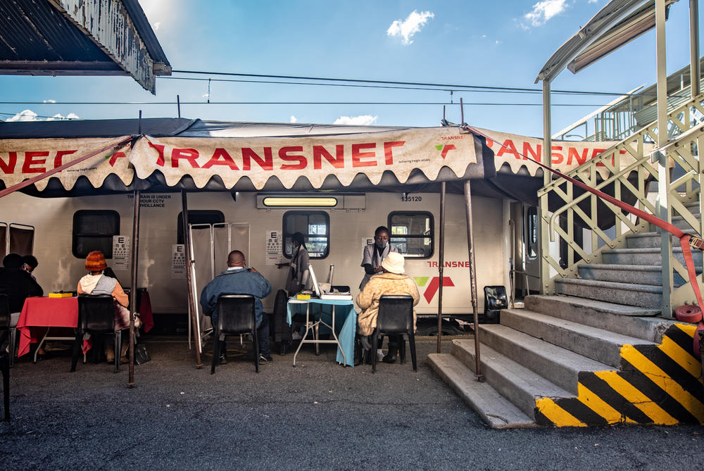 Patients get their eyes tested by medical staff outside the Phelophepa health-care train in Kroonstad, South Africa.