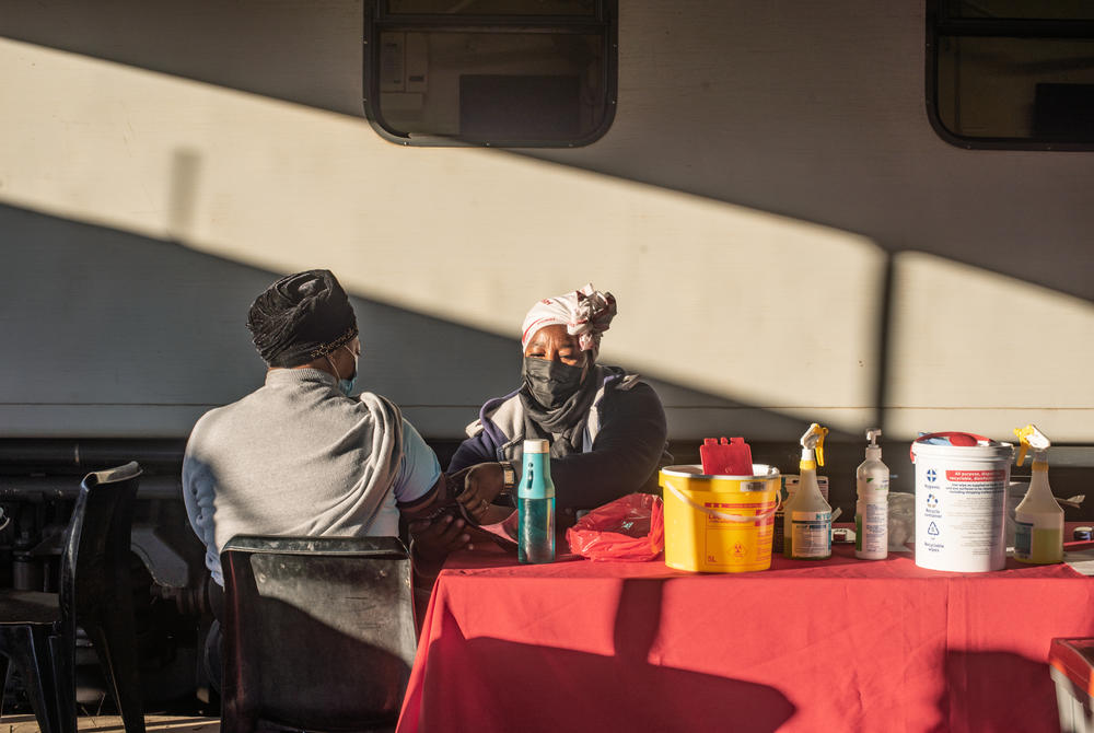 A nurse takes a patient's vital signs in the early morning at the Phelophepa in Thaba Nchu, South Africa.