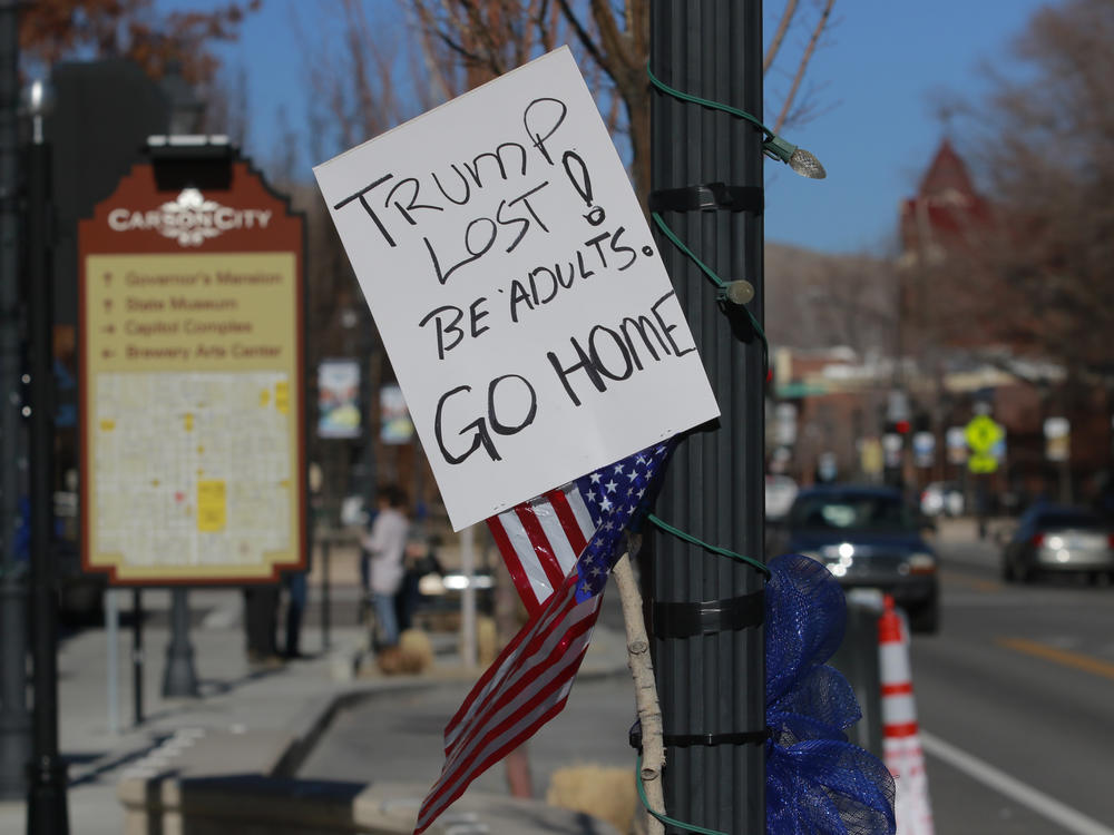 A sign in Carson City, Nevada in January 2021 calling on pro-Trump protesters, supporting his baseless claims of election fraud, to go home. Now, other candidates are following in Trump's footsteps.